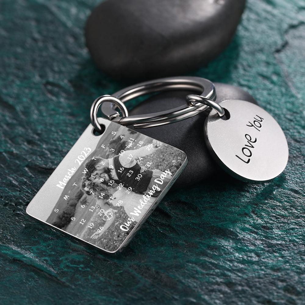 Keychain with photo and 'LOVE YOU' tag on a dark surface