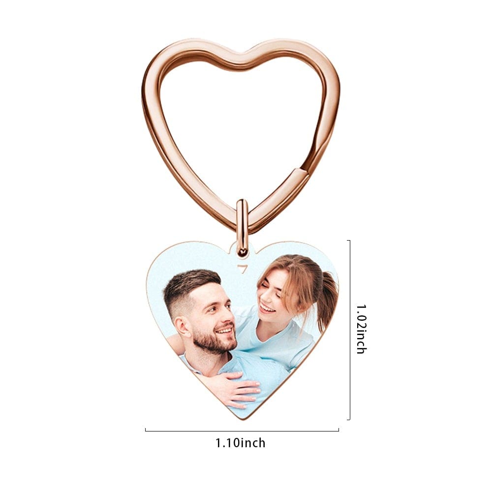 Heart-shaped keychain with a photo of a couple and dimensions on a white background