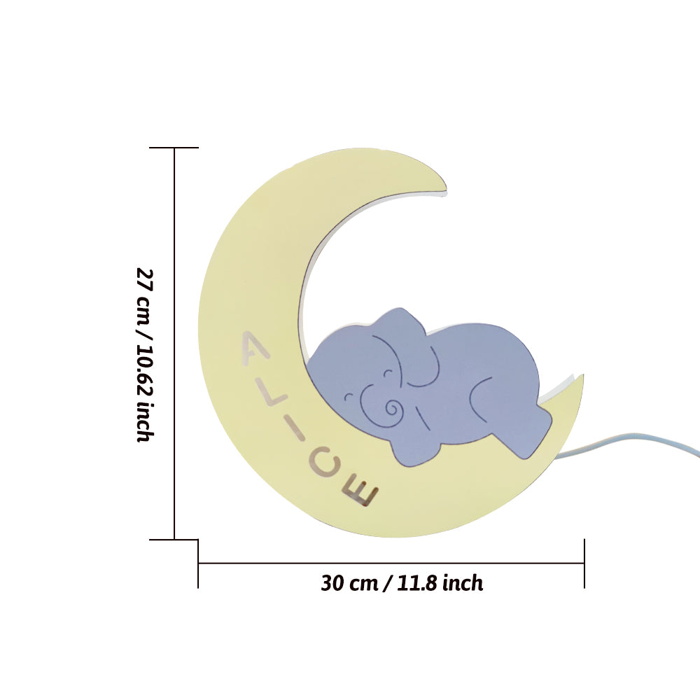 Decorative item with a blue elephant on a yellow crescent moon, showing dimensions.