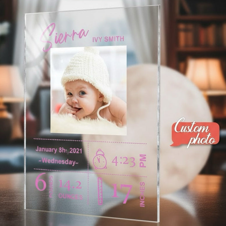 Clear acrylic plaque with baby photo and personalized text in a home setting