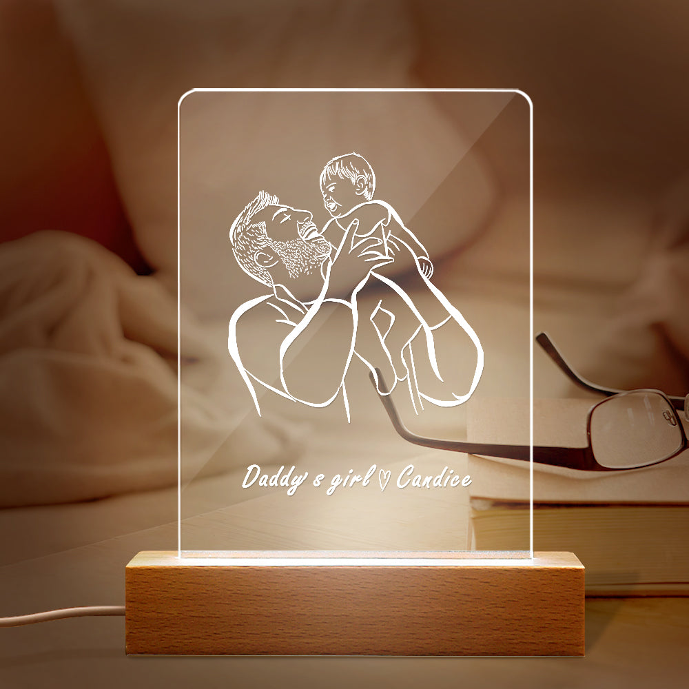 LED lamp with a design of a father holding a child and the text 'Daddy's girl Candice' on a wooden base.