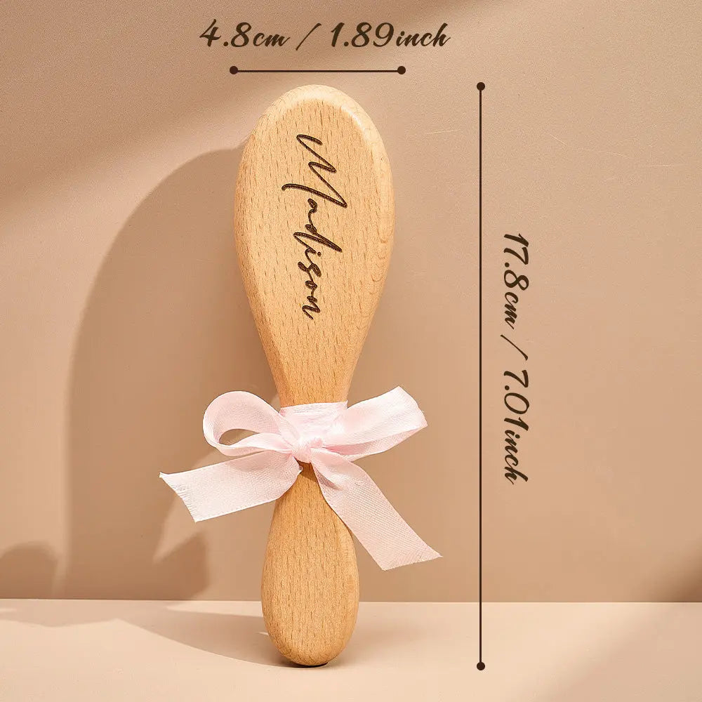 Wooden hairbrush with a pink ribbon and measurements on a beige background