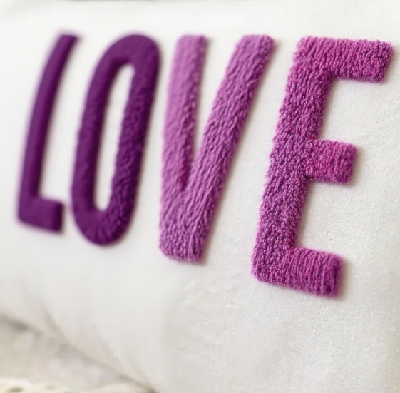 Purple textured letters spelling 'LOVE' on a white background