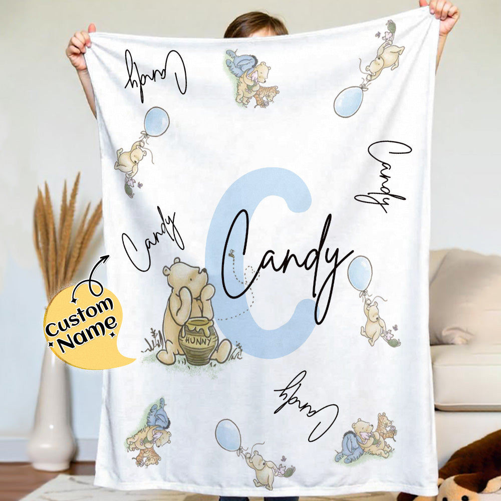 Person holding a blanket with cartoon characters and 'Candy' text, with a decorative item in the background.