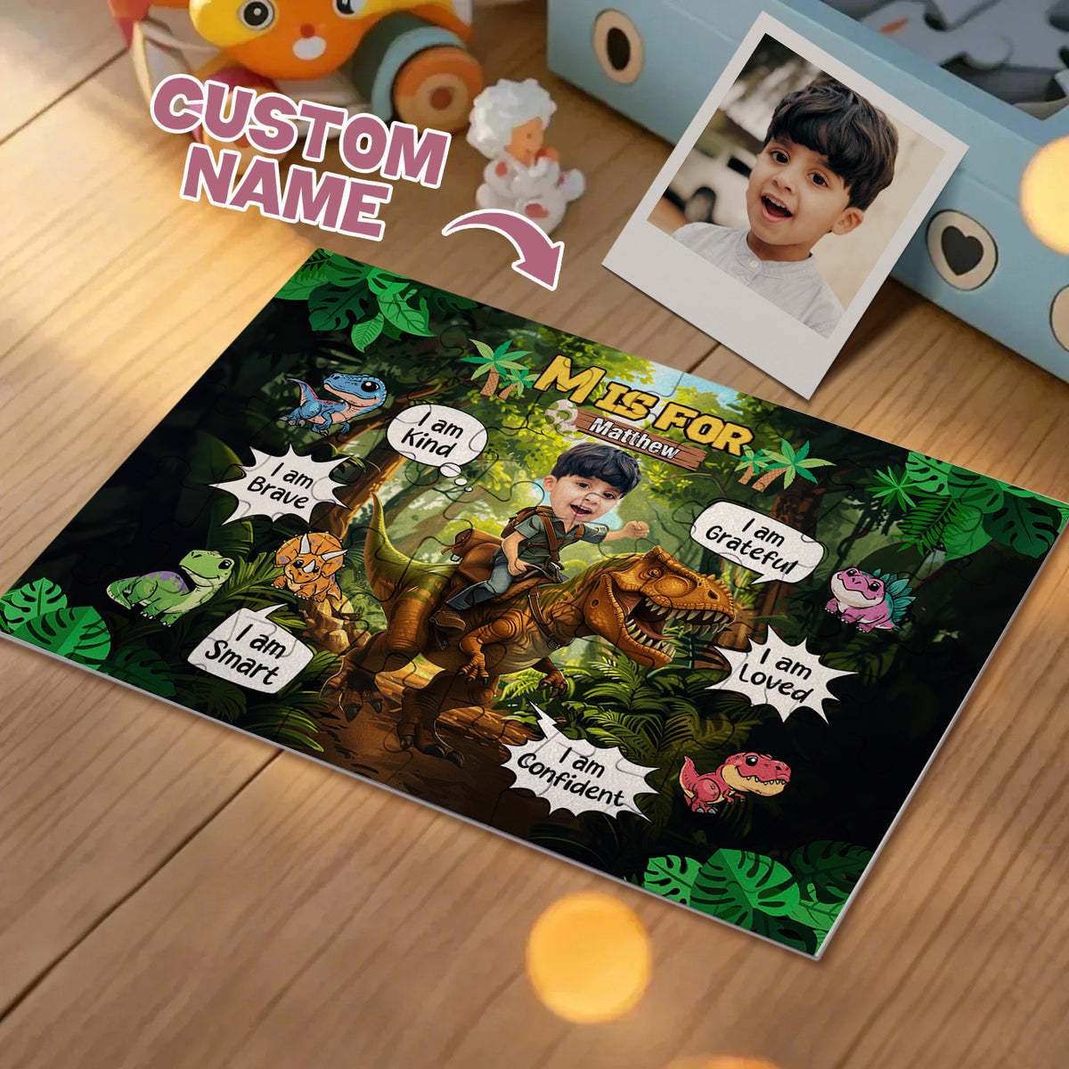 A personalized dinosaur-themed children's bedroom mat or poster lies on a wooden floor, featuring a cartoon jungle scene with a child's custom photo of a boy riding a dinosaur. The mat includes text like 'CUSTOM NAME', 'Mister For', and self-esteem phrases such as 'I am Brave', 'I am Gateful', 'I am Smart', 'I am Confident', 'I am Loved', and 'I am Helpful'.