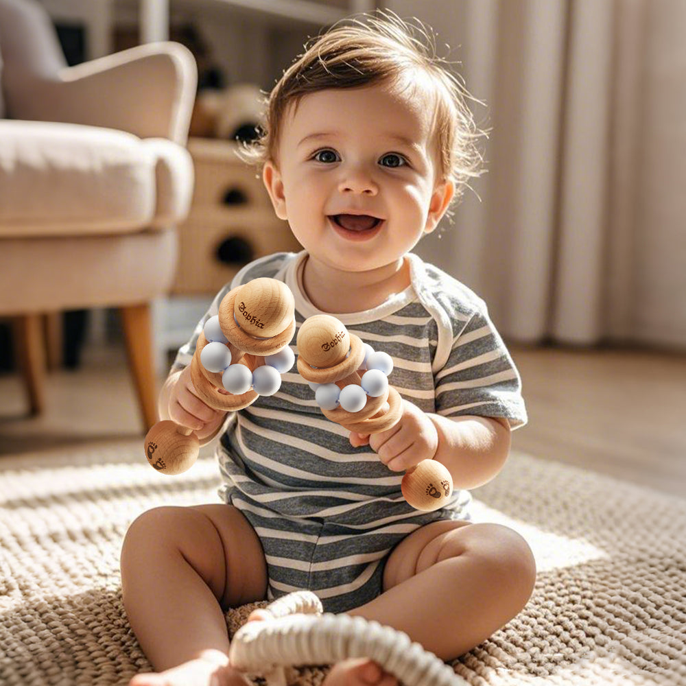 Baby holding wooden toys in a home setting