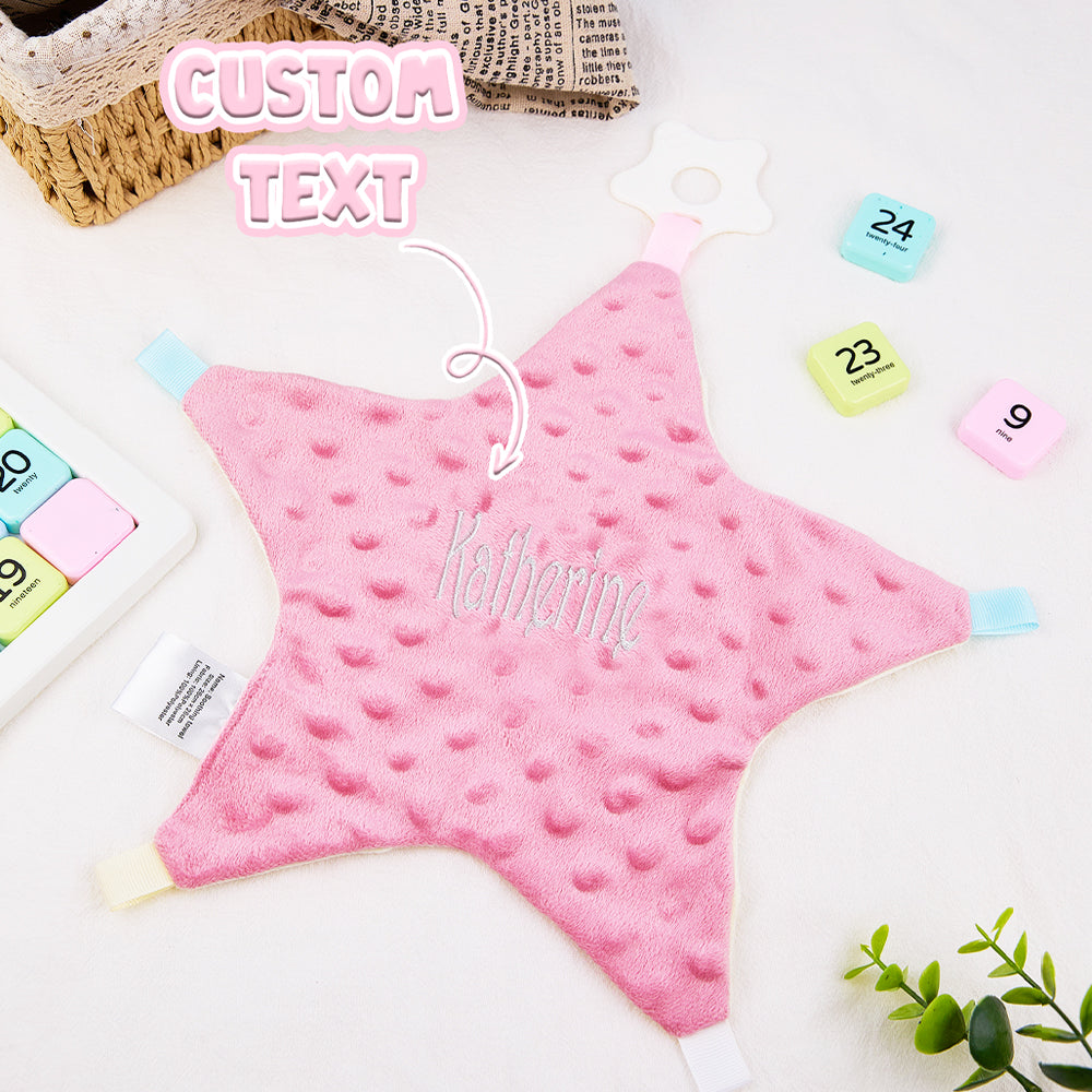 Pink star-shaped blanket with 'Katherine' text, surrounded by colorful numbers and a plant on a white background.