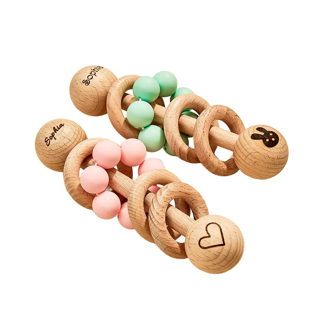 Wooden baby teething toys with colorful beads on a beige surface