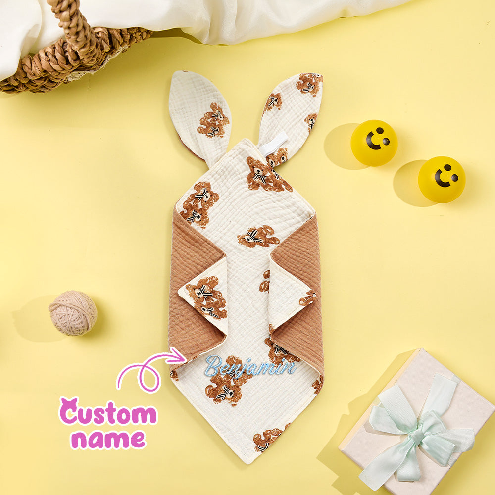 Bunny-shaped towel with teddy bear design on a yellow background
