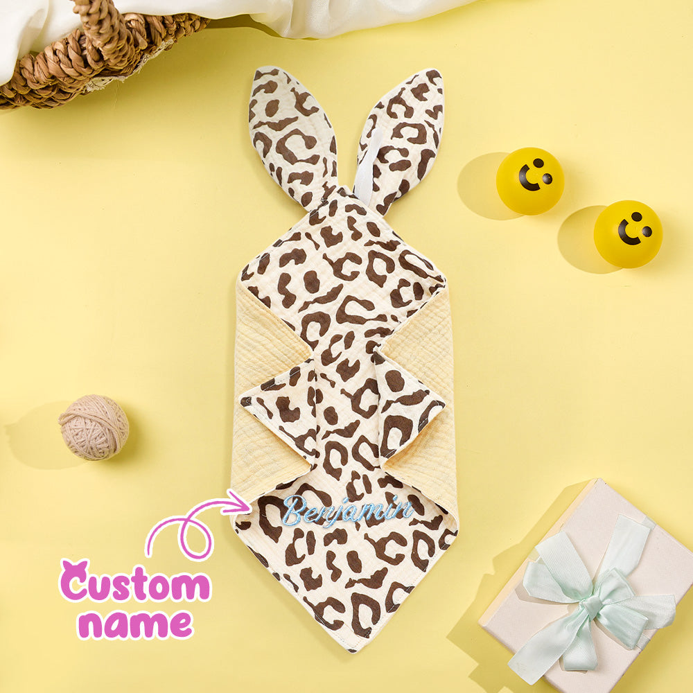 Leopard print bunny-shaped towel on a yellow background with decorative items.