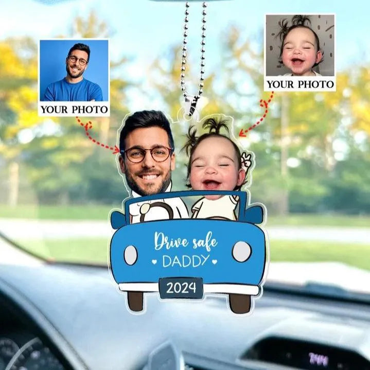 Car dashboard with a decorative cutout of a man and child in a blue car, with text 'Drive safe DADDY 2024'.