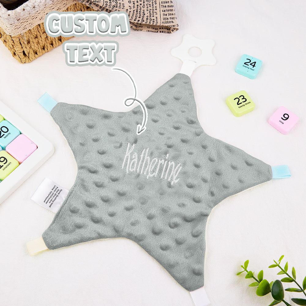 Star-shaped gray pillow with 'Katherine' text on a white surface with colorful sticky notes.