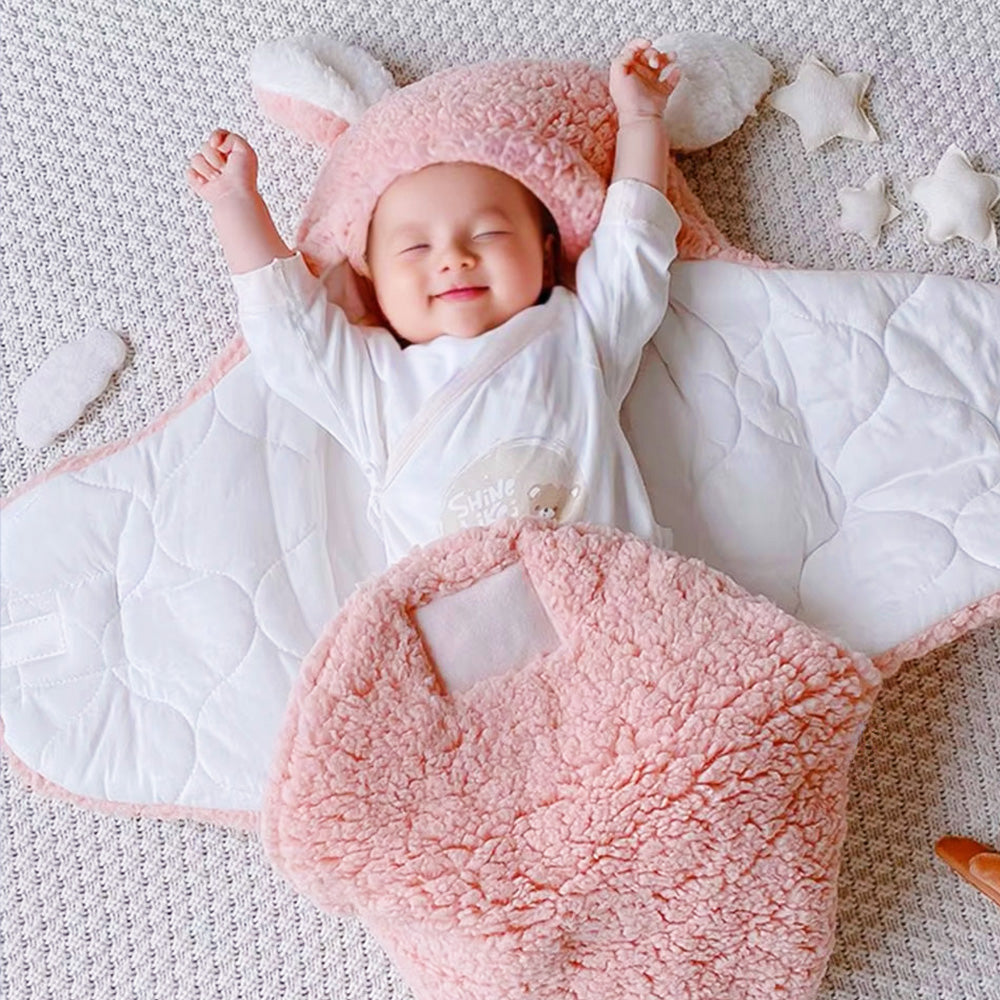 Baby in a pink and white outfit with a matching hat, lying on a textured surface.