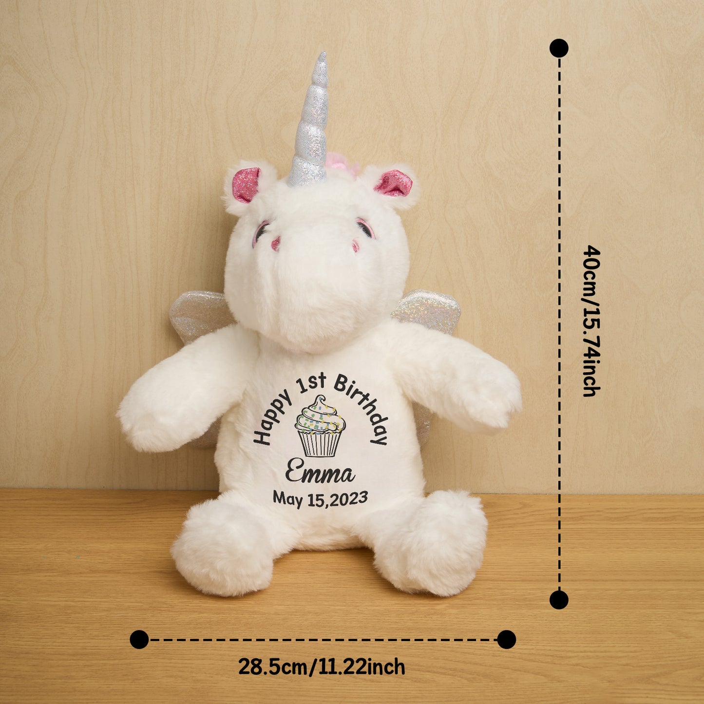 White unicorn plush toy with measurements on a wooden surface