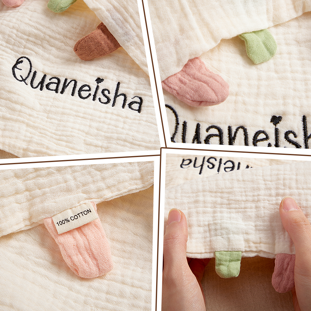 Baby blanket with embroidered name 'Quaneisha' and 100% cotton tag.