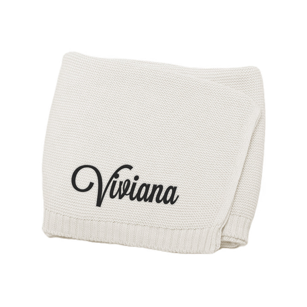 Folded beige blanket with 'Viviana' embroidery on a white background
