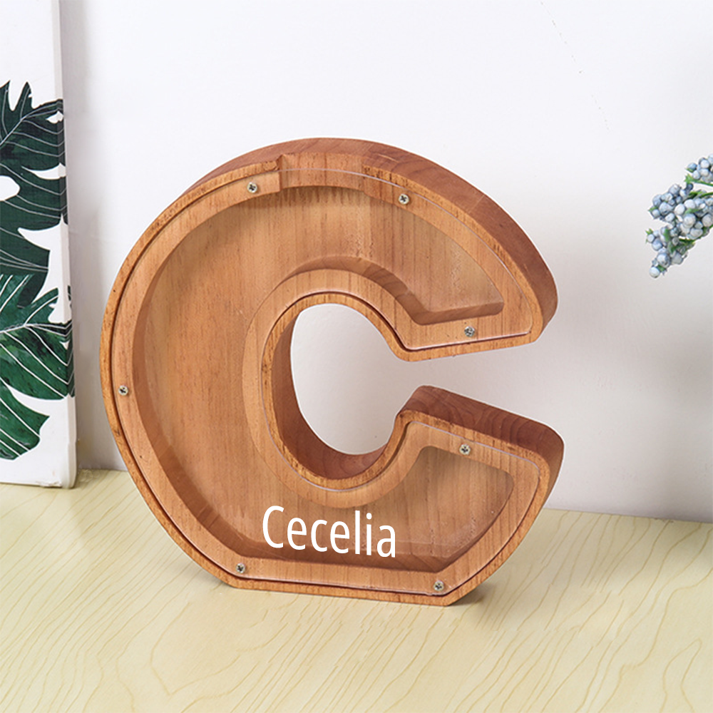 Wooden letter 'C' with 'Cecelia' engraved, on a light wooden surface with a white background.
