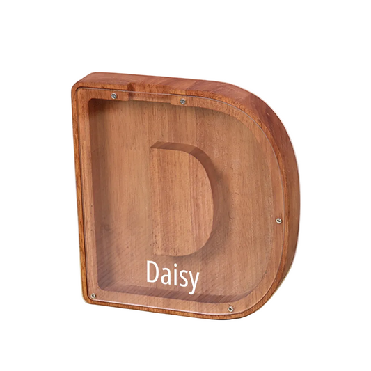 Wooden pet bed with 'Daisy' engraving on a light wooden floor.