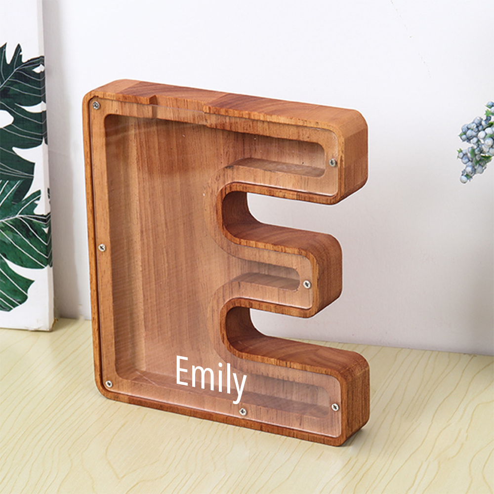 Wooden letter 'E' with 'Emily' engraved, on a light wooden surface.