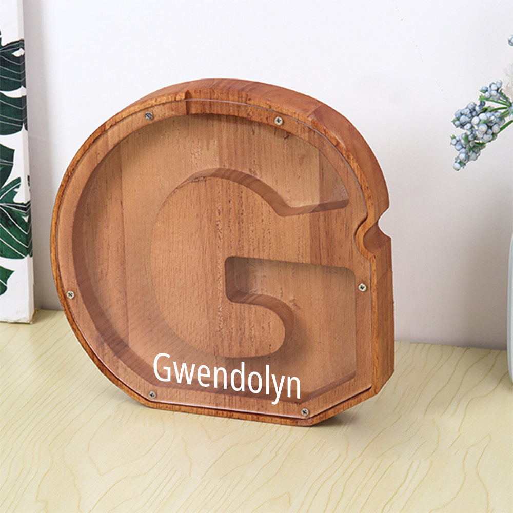 Wooden letter 'G' with 'Gwendolyn' engraved on a light wooden surface.