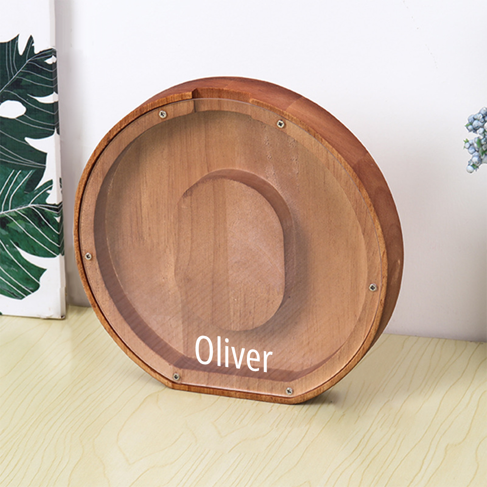 Wooden decorative item with 'Oliver' engraving on a light wooden surface.