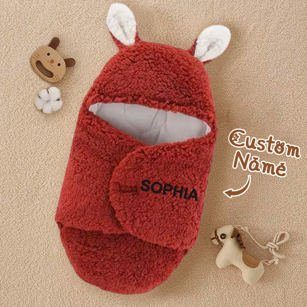 Red baby wrap with rabbit ears and 'SOPHIA' branding on a beige background