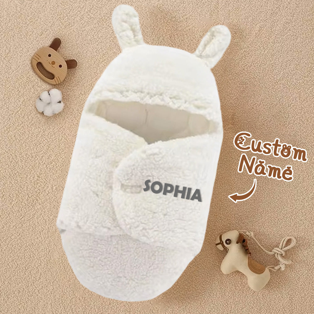 White baby wrap with bunny ears and 'SOPHIA' branding on a beige background