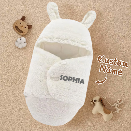 White baby wrap with bunny ears and 'SOPHIA' branding on a beige background