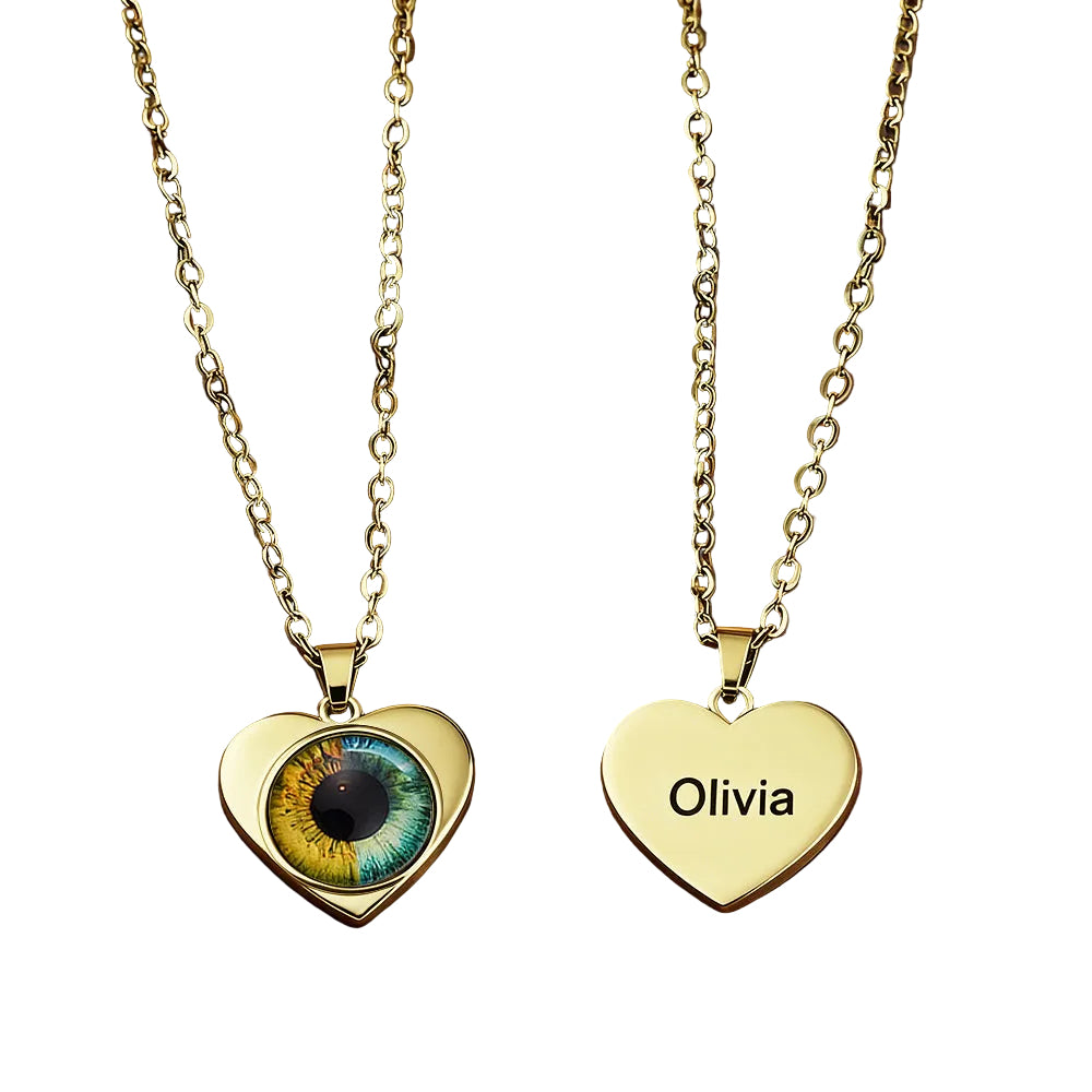 Two gold heart-shaped pendants on a leather surface