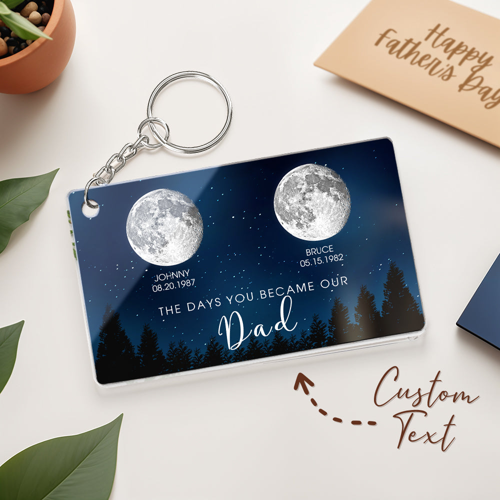 Personalized keychain with moon design and text on a white surface with a 'Happy Father's Day' card.
