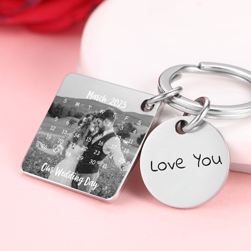 Keychain with calendar and 'Love You' tag on a pink background