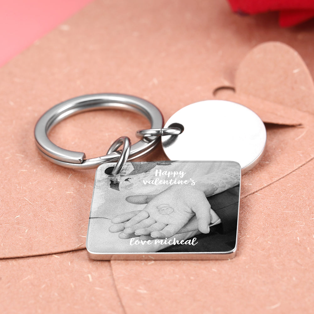 Keychain with a photo tag and 'Happy Valentine's' text on a pink surface