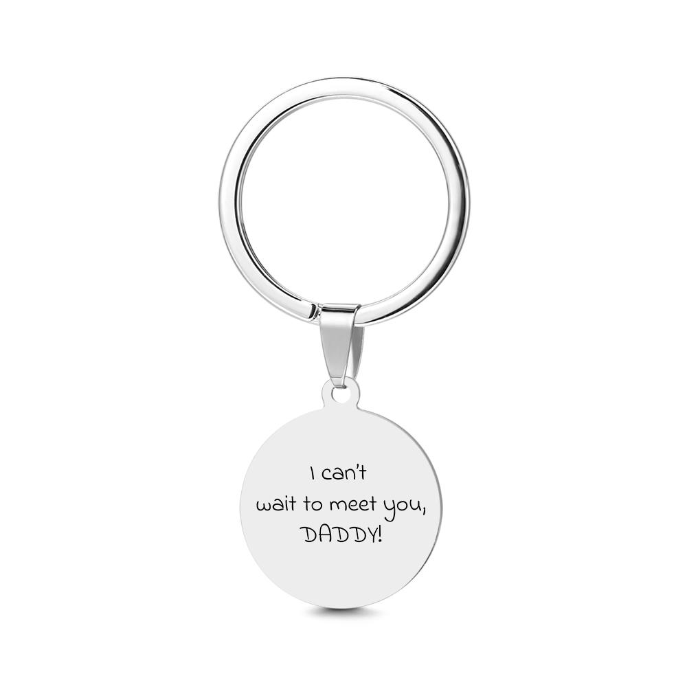 Silver keychain with 'I can't wait to meet you, DADDY!' text on a white background