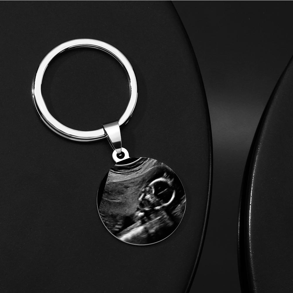 Keychain with ultrasound photo on a black surface