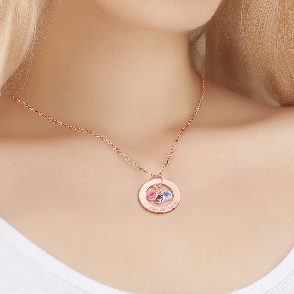 Rose gold necklace with a circular pendant featuring colorful stones on a mannequin.