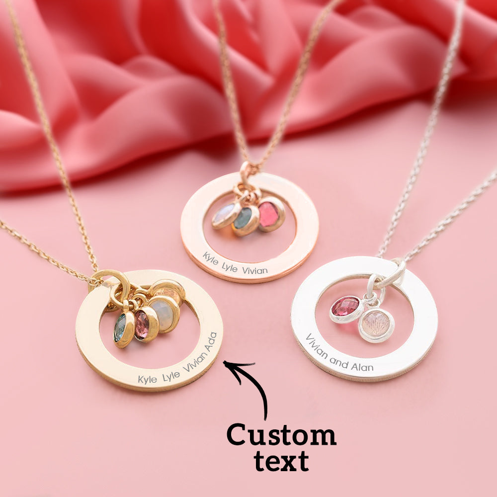 Three personalized necklaces with circular pendants and engraved names on a pink fabric background.