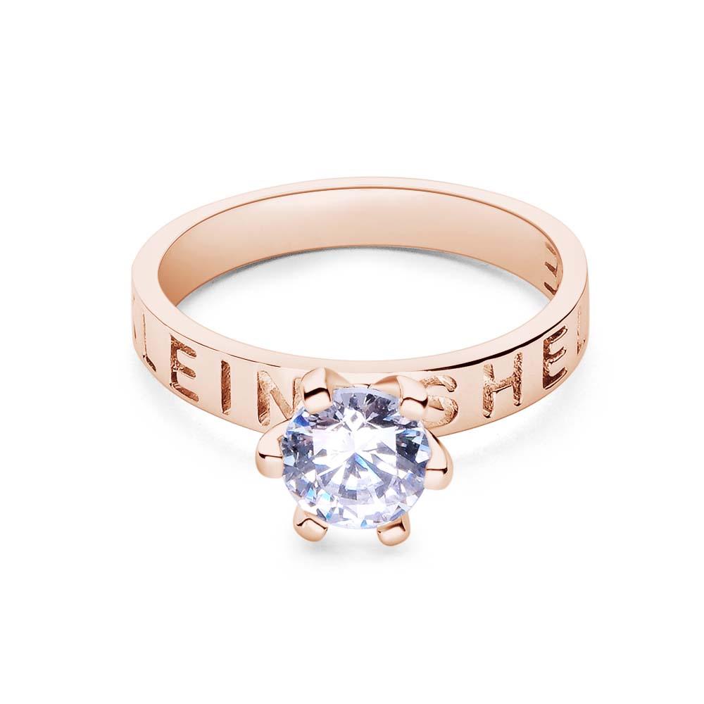 Rose gold ring with a diamond on a white background