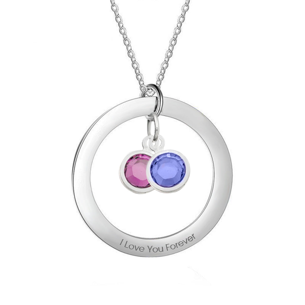 Silver necklace with circular pendant and colored stones on a white background