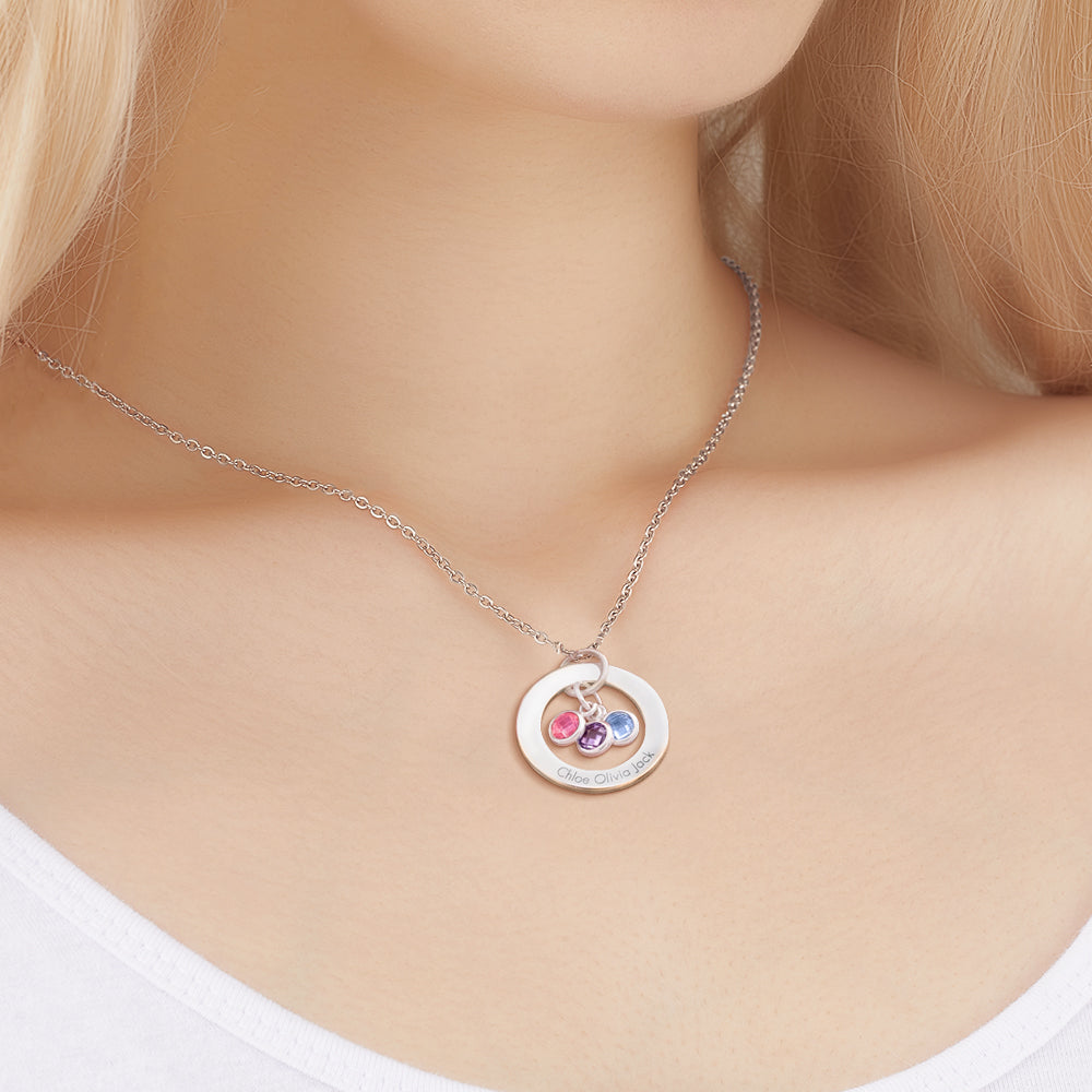 Necklace with a circular pendant featuring colorful stones on a mannequin.