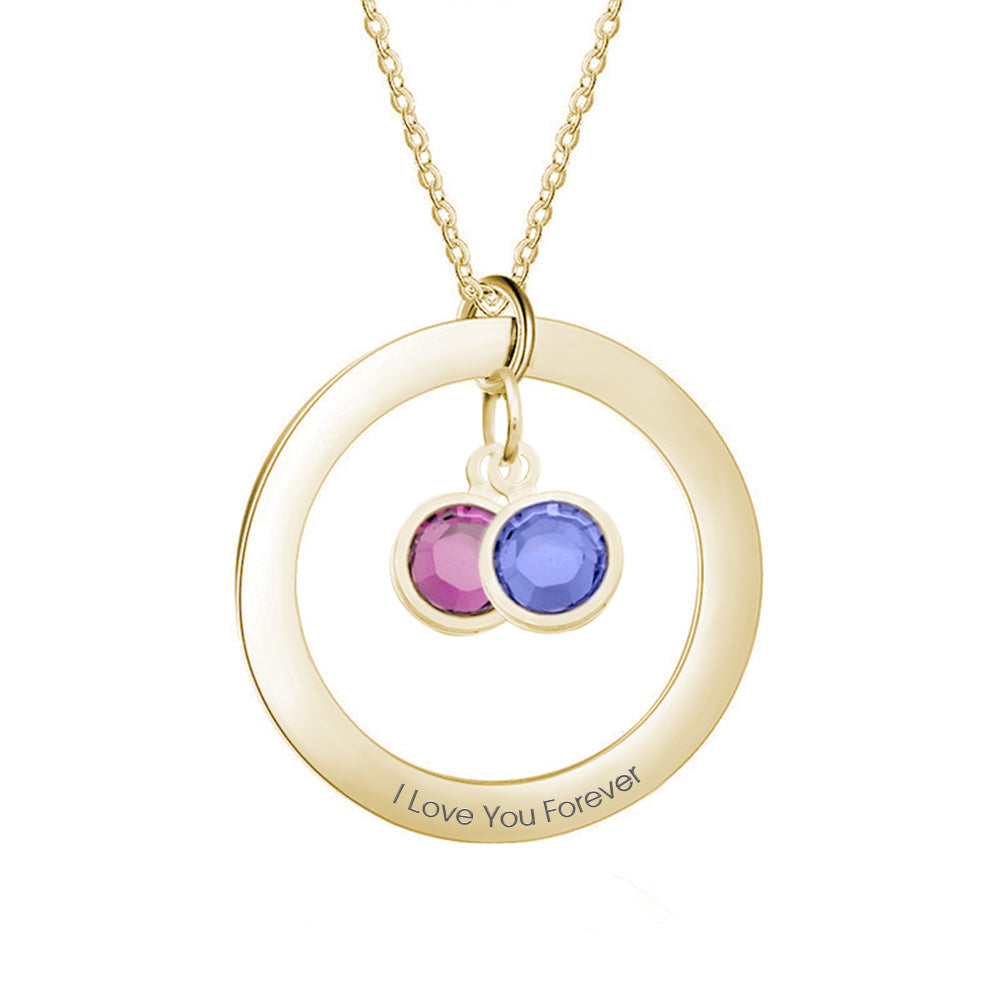 Gold necklace with circular pendant and colored stones on a white background