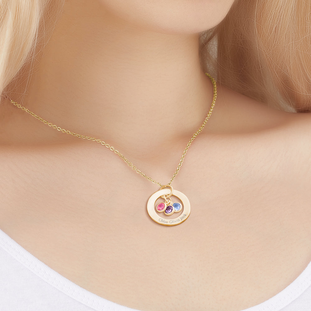 Gold necklace with a circular pendant featuring colored stones on a mannequin.