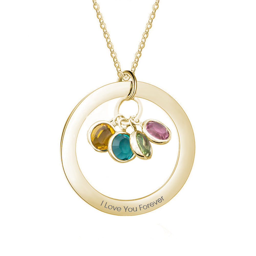 Gold necklace with circular pendant and colored gemstones on a white background