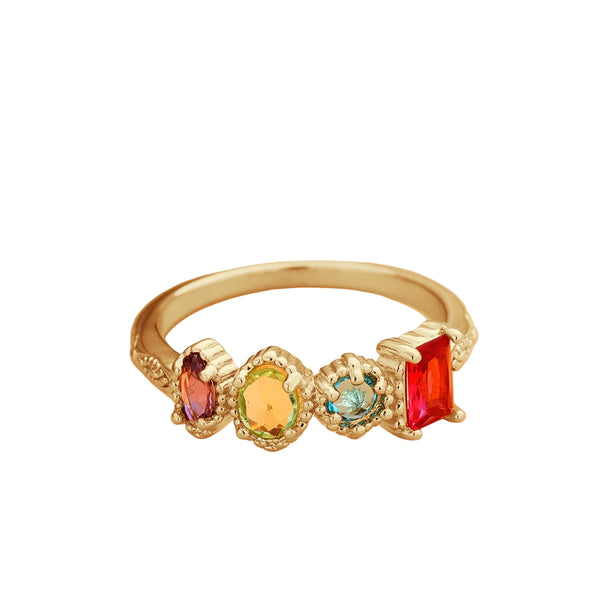 Gold ring with colorful gemstones on a light background