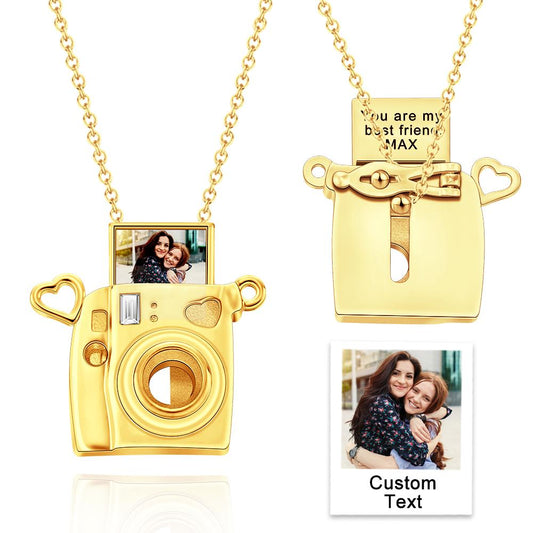 Gold camera-shaped pendant with a chain, featuring a photo insert and customizable text on a white background.