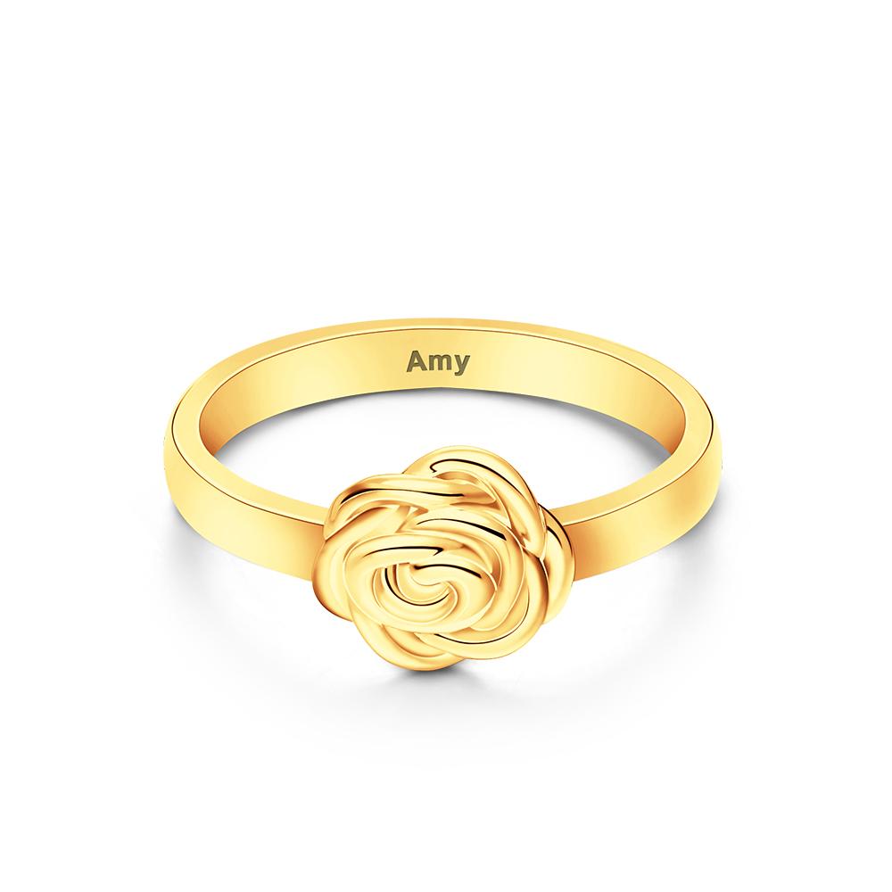 Gold ring with a rose design and 'Amy' engraving on a white background