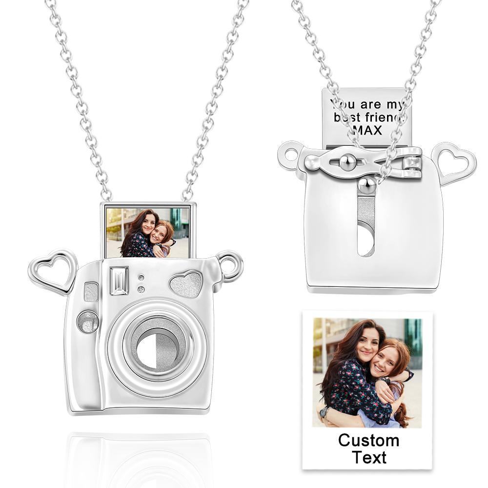 Camera-shaped pendant with heart accents and a chain, featuring a photo of two people and customizable text.