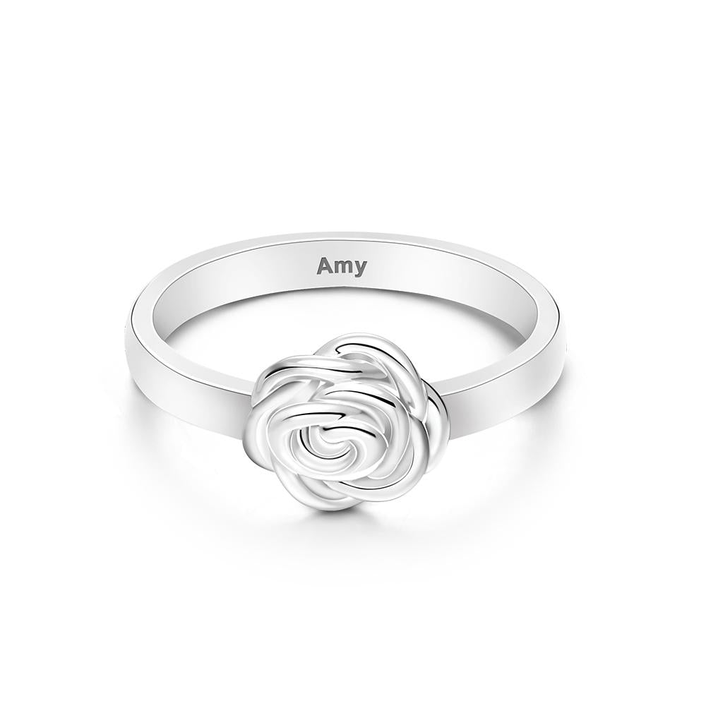 Silver ring with rose design and 'Amy' engraving on a white background