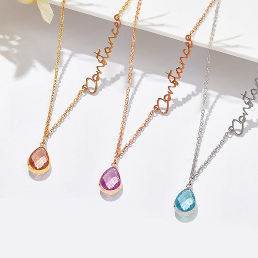 Three necklaces with teardrop-shaped gemstones on a white surface