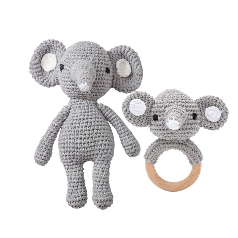 Crocheted elephant toy and ring on a white background