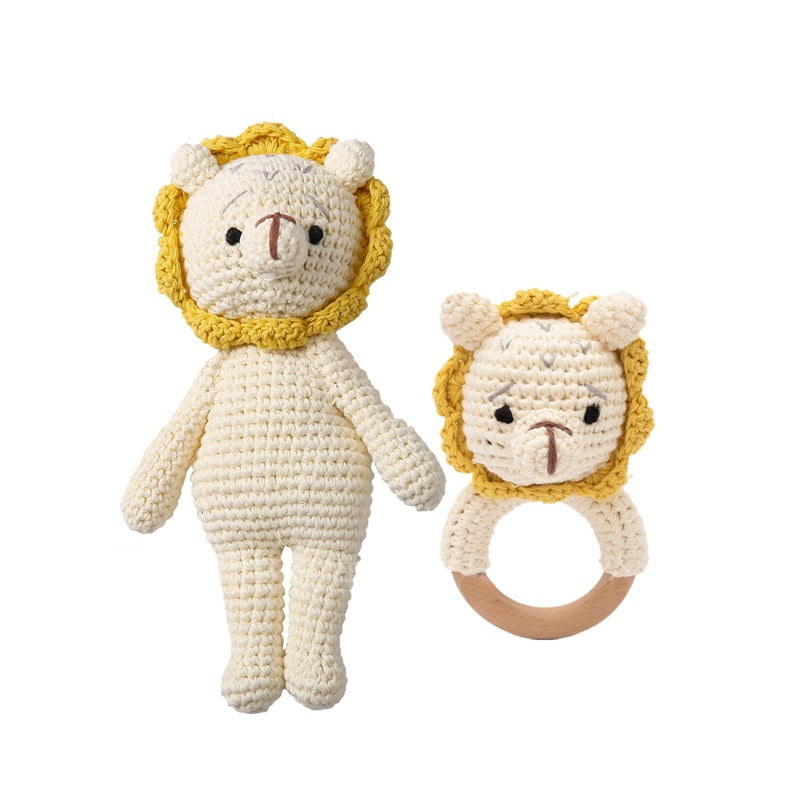 Crocheted lion toy and rattle on a white background
